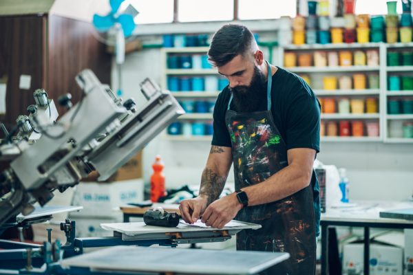 male-worker-preparing-screen-printing-film-in-a-wo-2022-04-18-23-16-23-utc